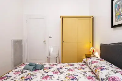 a bedroom with a bed and a yellow closet at Ripetta Beauty House in Rome