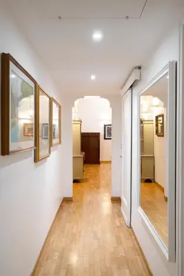 a hallway with white walls and wooden floors at Ripetta Beauty House in Rome
