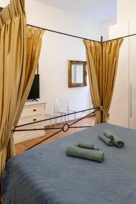 a bedroom with a bed with two green towels on it at Ripetta Beauty House in Rome