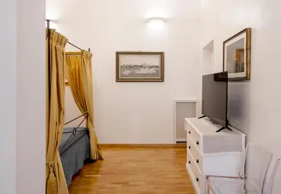 a living room with a couch and a tv at Ripetta Beauty House in Rome