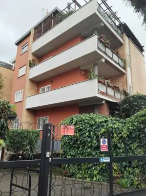 a building with a fence in front of it at Casa Sorelle Marchisio in Rome