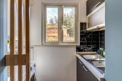a kitchen with a sink and a window at Appartamento centro storico BACCINAHOME in Rome
