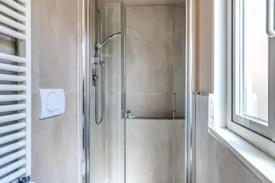 a shower with a glass door in a bathroom at Appartamento centro storico BACCINAHOME in Rome