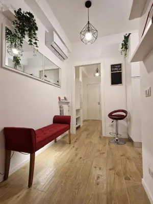 a living room with a red bench and a stool at La casa di Eurialo in Rome