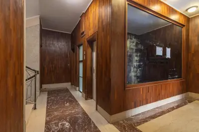 a hallway with wood paneled walls and a door at La Dimora del Vagamondo - ingresso in comune in Rome