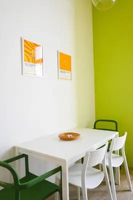 a white table and chairs in a room with green walls at Casa Pesa 2 rooms 2 baths Rome center in Rome