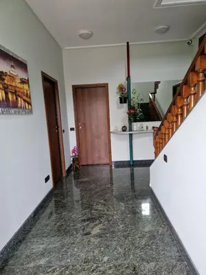 a hallway with a staircase and a wooden door at Castelbarco House B in Rome
