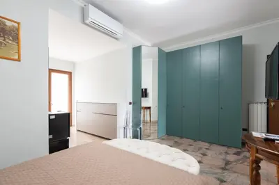 a bedroom with a bed and a blue wall at Castelbarco House B in Rome