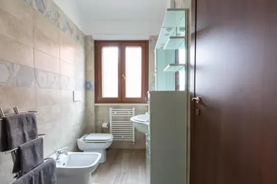 a bathroom with a toilet and a sink and a mirror at Castelbarco House B in Rome