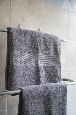 two towels hanging on a towel rack in a bathroom at Castelbarco House B in Rome