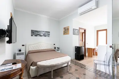 a bedroom with a bed and a television in it at Castelbarco House B in Rome