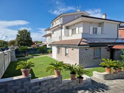 a house with potted plants in front of a yard at Castelbarco House A in Rome