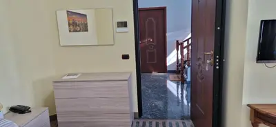 a room with a hallway with a door and a dresser at Castelbarco House A in Rome