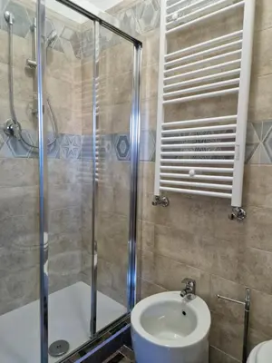 a bathroom with a shower and a sink and a toilet at Castelbarco House A in Rome