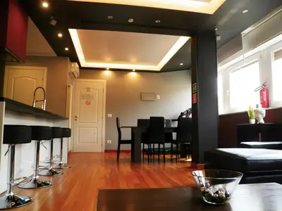 a dining room with a table and black chairs at Auditorium Deluxe in Rome