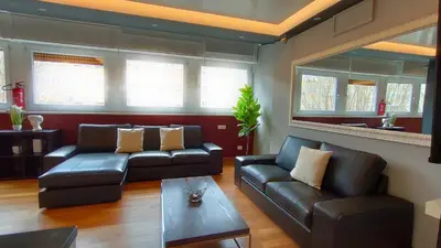 a living room with two leather couches and a table at Auditorium Deluxe in Rome