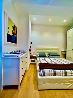 a bedroom with a bed and a dresser in it at Auditorium luxury suite Roma in Rome