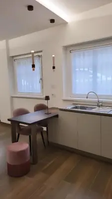 a kitchen with a table and chairs and a sink at Buongiorno al Vaticano in Rome