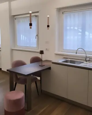 a kitchen with a sink and a table and chairs at Buongiorno al Vaticano in Rome