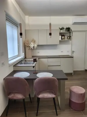 a kitchen with a table and two chairs and a sink at Buongiorno al Vaticano in Rome