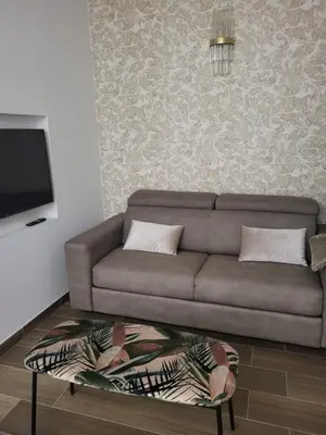 a living room with a couch and a flat screen tv at Buongiorno al Vaticano in Rome