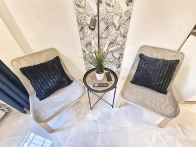 two chairs and a table with a potted plant at Tiber Apartment in Trastevere in Rome