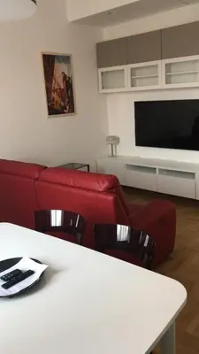 a living room with a red couch and a table at Colosseum Rome Guest House Luil in Rome