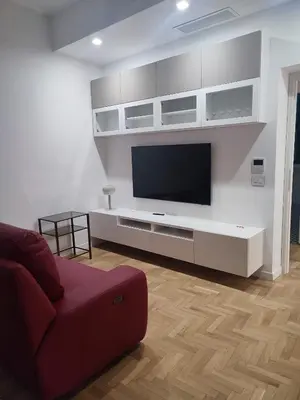 a living room with a flat screen tv on a wall at Colosseum Rome Guest House Luil in Rome