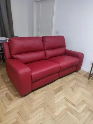 a red couch sitting in a living room at Colosseum Rome Guest House Luil in Rome