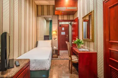 a small room with a bed and a desk with a desk at Castro Pretorio 64 Easy Rooms in Rome