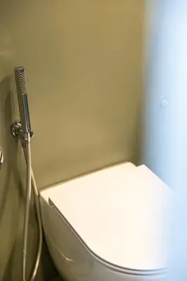 a bathroom with a toilet with a hose attached to it at Best Room Catone 21 in Rome