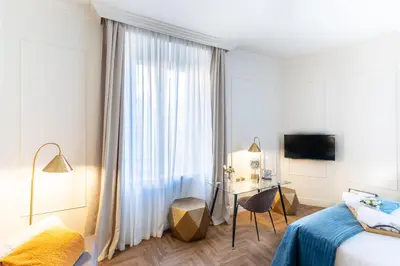 a bedroom with a bed and a desk and a window at Best Room Catone 21 in Rome