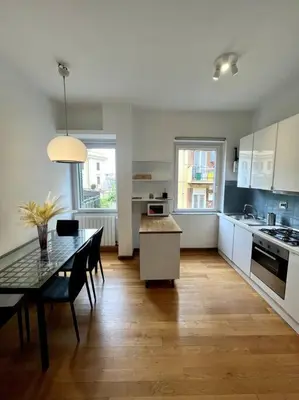 a kitchen with a table and a dining room at St. Peter Home Private Terrace in Rome