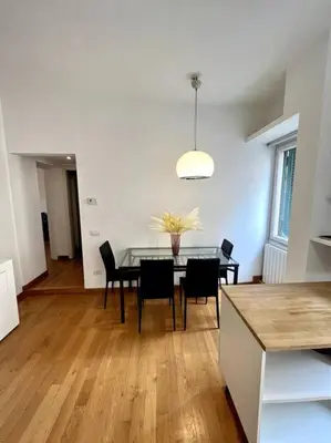 a kitchen and dining room with a table and chairs at St. Peter Home Private Terrace in Rome