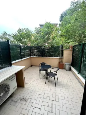 a patio with two chairs and a table on a balcony at St. Peter Home Private Terrace in Rome