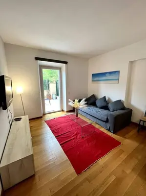 a living room with a couch and a red rug at St. Peter Home Private Terrace in Rome