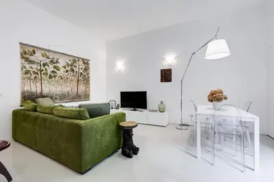 a living room with a green couch and a table at Colosseo Exclusive House by Premium Suites Collection in Rome