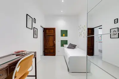 a bedroom with a desk and a bed in a room at Colosseo Exclusive House by Premium Suites Collection in Rome