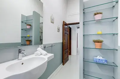 a bathroom with a sink and a mirror at Colosseo Exclusive House by Premium Suites Collection in Rome