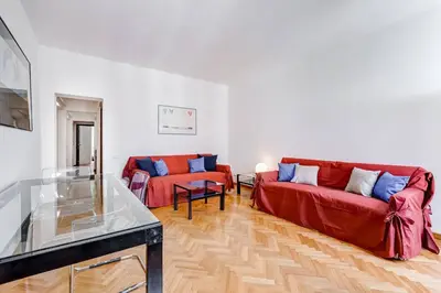 a living room with two red couches and a table at Luminous Apartment few steps from Piazza Navona in Rome