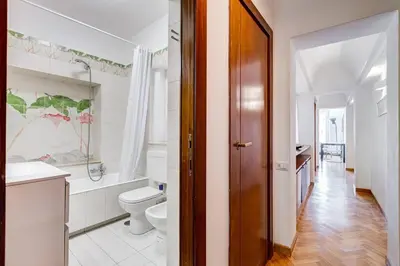 a white bathroom with a toilet and a sink at Luminous Apartment few steps from Piazza Navona in Rome