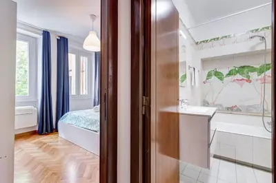 a bathroom with a tub and a sink and a bed at Luminous Apartment few steps from Piazza Navona in Rome