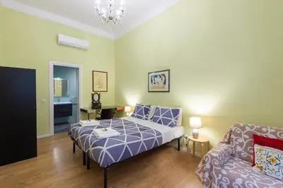 a bedroom with a bed and a couch at Luxury Three Bedrooms flat in Roma Center in Rome