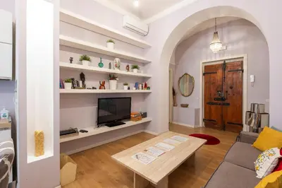a living room with a tv and a table at Luxury Three Bedrooms flat in Roma Center in Rome