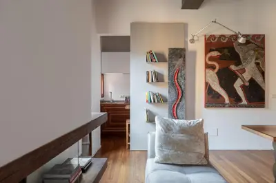 a living room with a couch and a painting on the wall at iFlat Loft&Pool in Trastevere in Rome