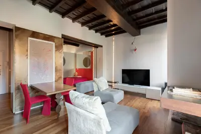 a living room with a couch and a table and chairs at iFlat Loft&Pool in Trastevere in Rome