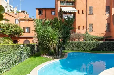 a swimming pool in a yard next to a building at iFlat Loft&Pool in Trastevere in Rome