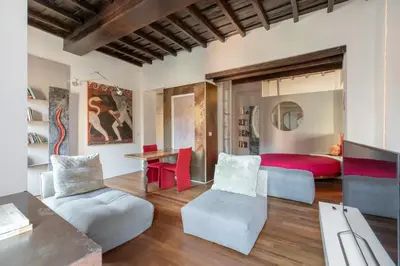 a living room with a bed and a table and chairs at iFlat Loft&Pool in Trastevere in Rome
