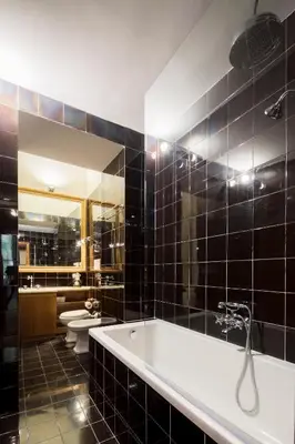 a bathroom with a tub and a toilet and a mirror at Palazzo Berardi: Renaissance Downtown Luxury Villa in Rome