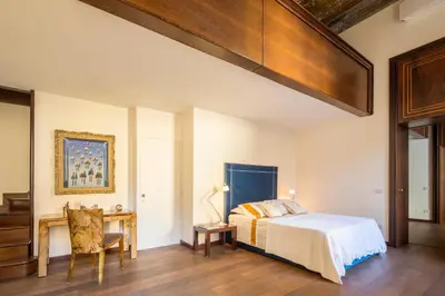 a bedroom with a bed and a desk at Palazzo Berardi: Renaissance Downtown Luxury Villa in Rome